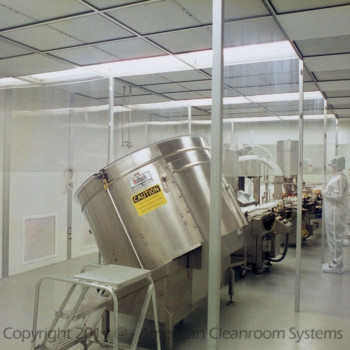 interior of ISO7 modular cleanroom, multiple large mixing vats, clear vinyl cleanroom curtain,