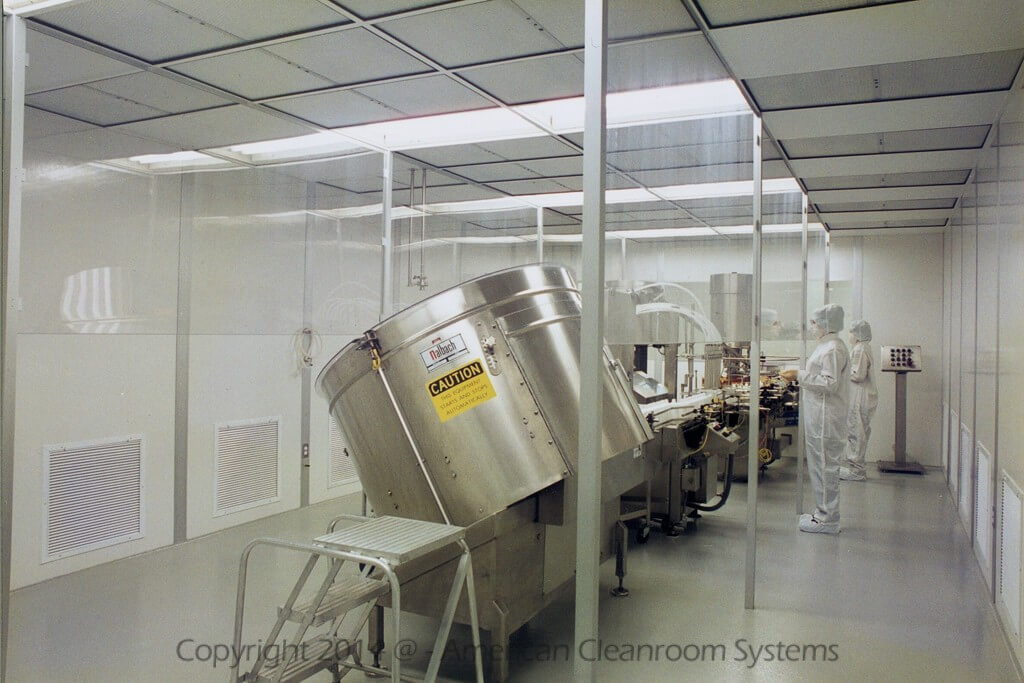 modular cleanroom with interior clear curtains, large metal mixing vats