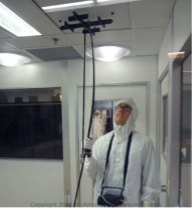 technician in bunny suit, testing cleanroom air flow