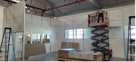 cleanroom modular walls being erected, scissor lift