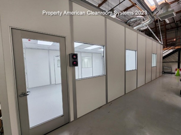 “exterior of ISO-7 medical device cleanroom” “white modular cleanroom walls” “aluminum storefront cleanroom door”  