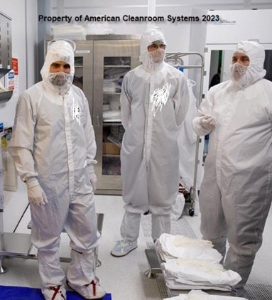 “3 people wearing cleanroom garments” “white bunny suits
