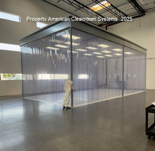 interior of class 1000 modular cleanroom, amber lighting, cleanroom doors, low wall air return