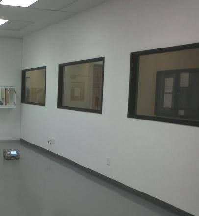 interior of class 1000 modular cleanroom, amber lighting, cleanroom doors, low wall air return